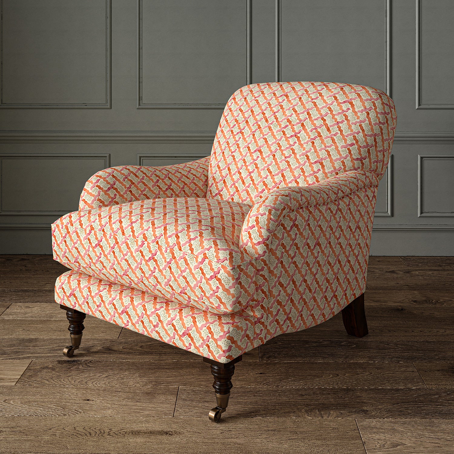 Printed linen fabric - a contemporary lattice design in red, pink, cream and white – on an armchair