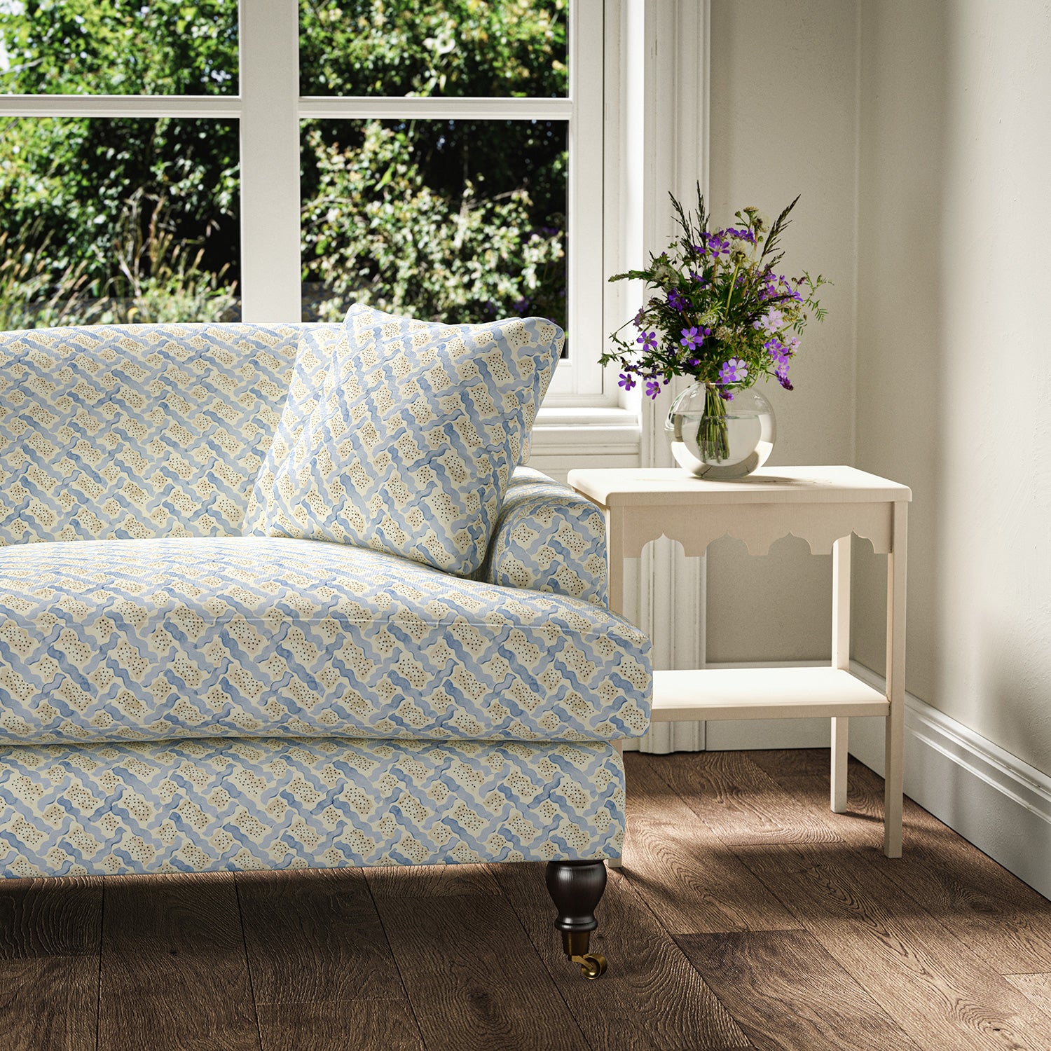 Printed linen fabric - a contemporary lattice design in blue, cream and white – on a sofa