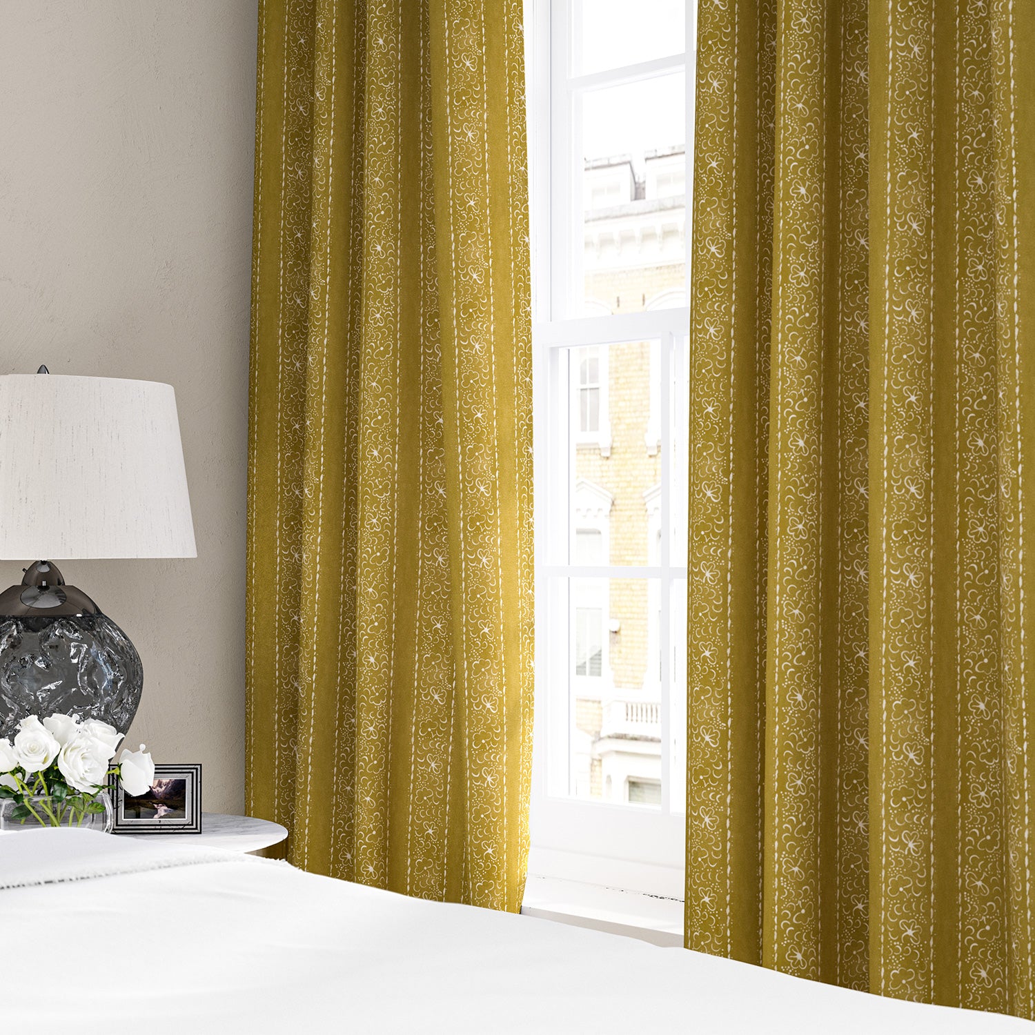 Linen curtains with a delicate pattern of moons and star-like dots in yellow and cream