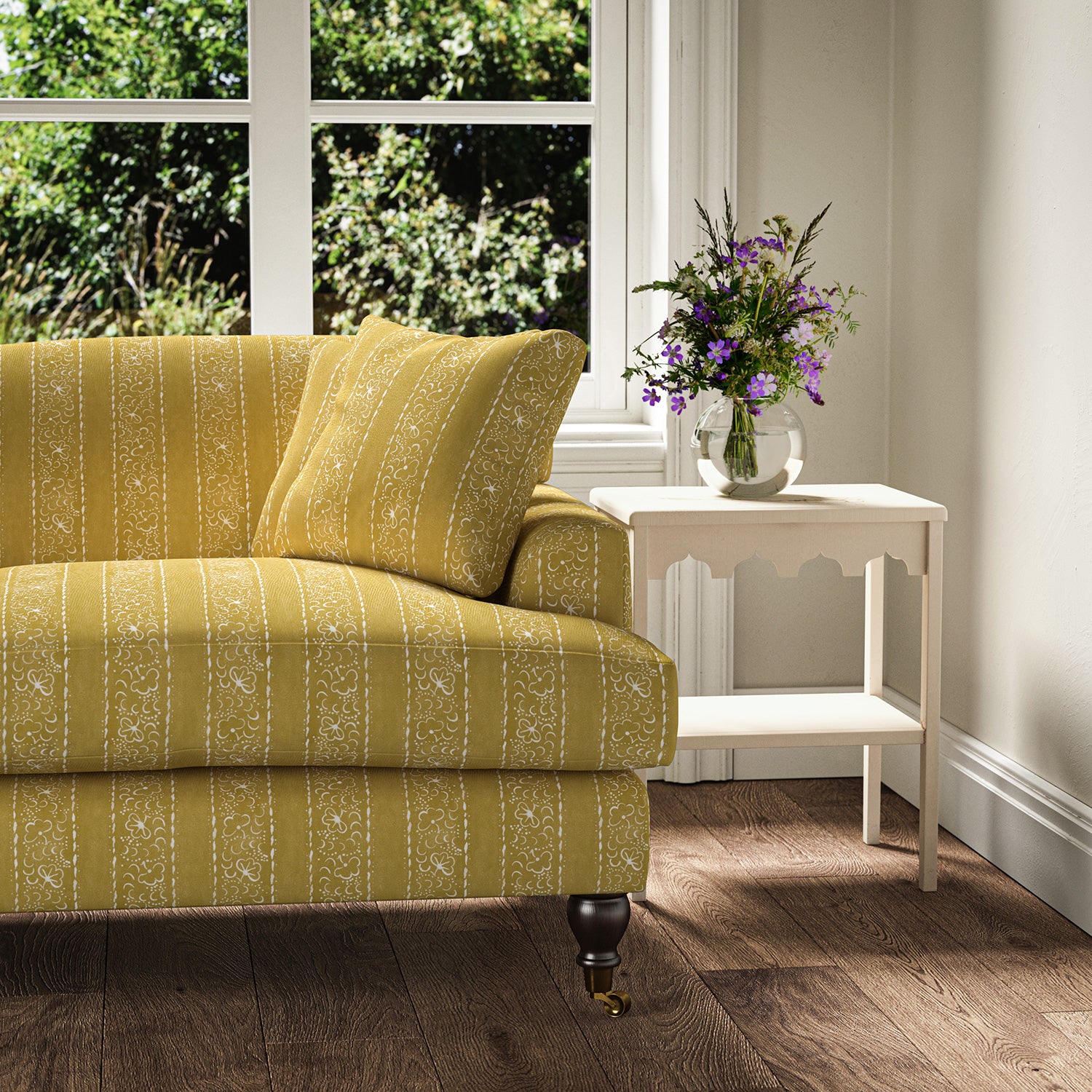 Printed linen fabric – a delicate pattern of moons and star-like dots in yellow and cream – on a sofa