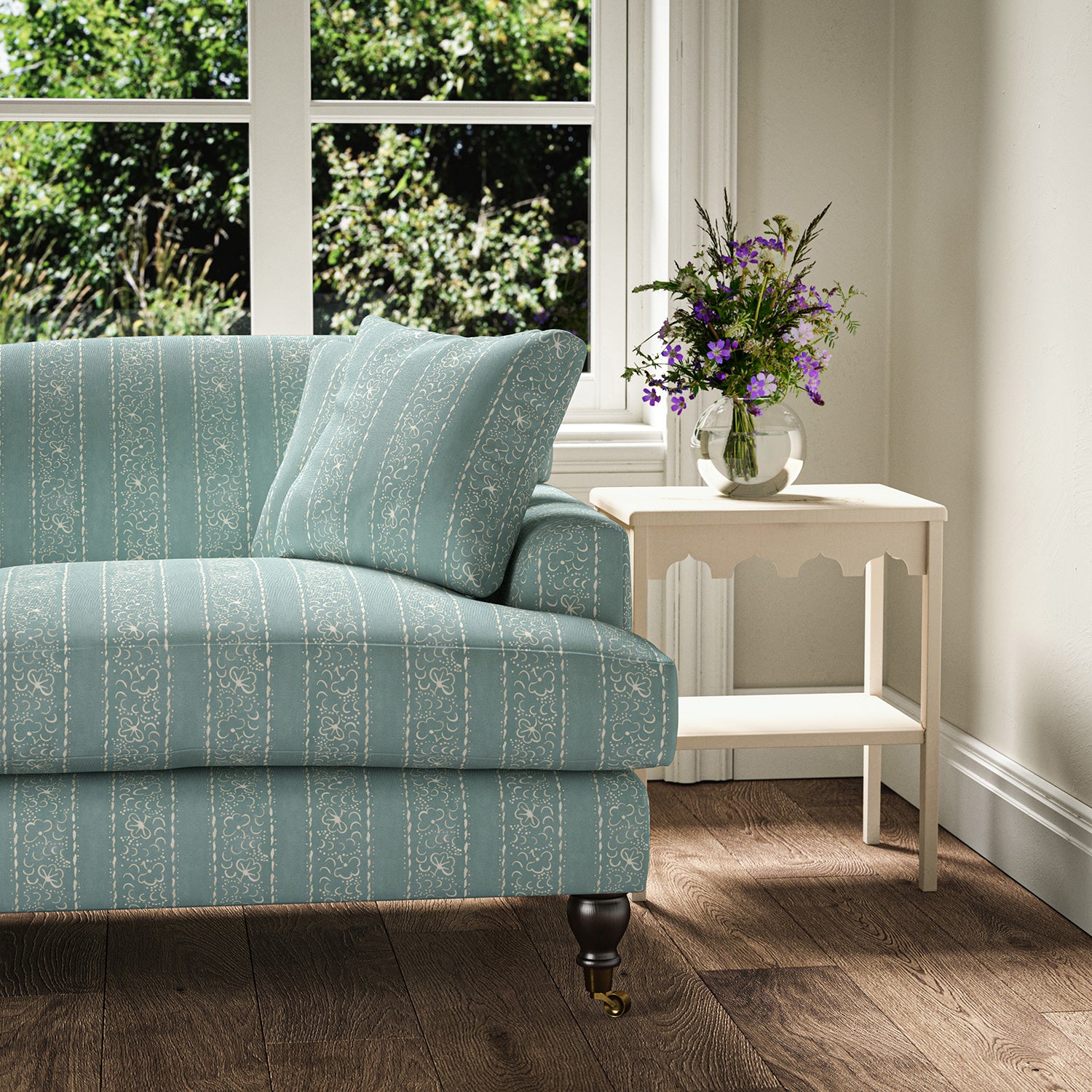 Printed linen fabric – a delicate pattern of moons and star-like dots in blue and cream – on a sofa