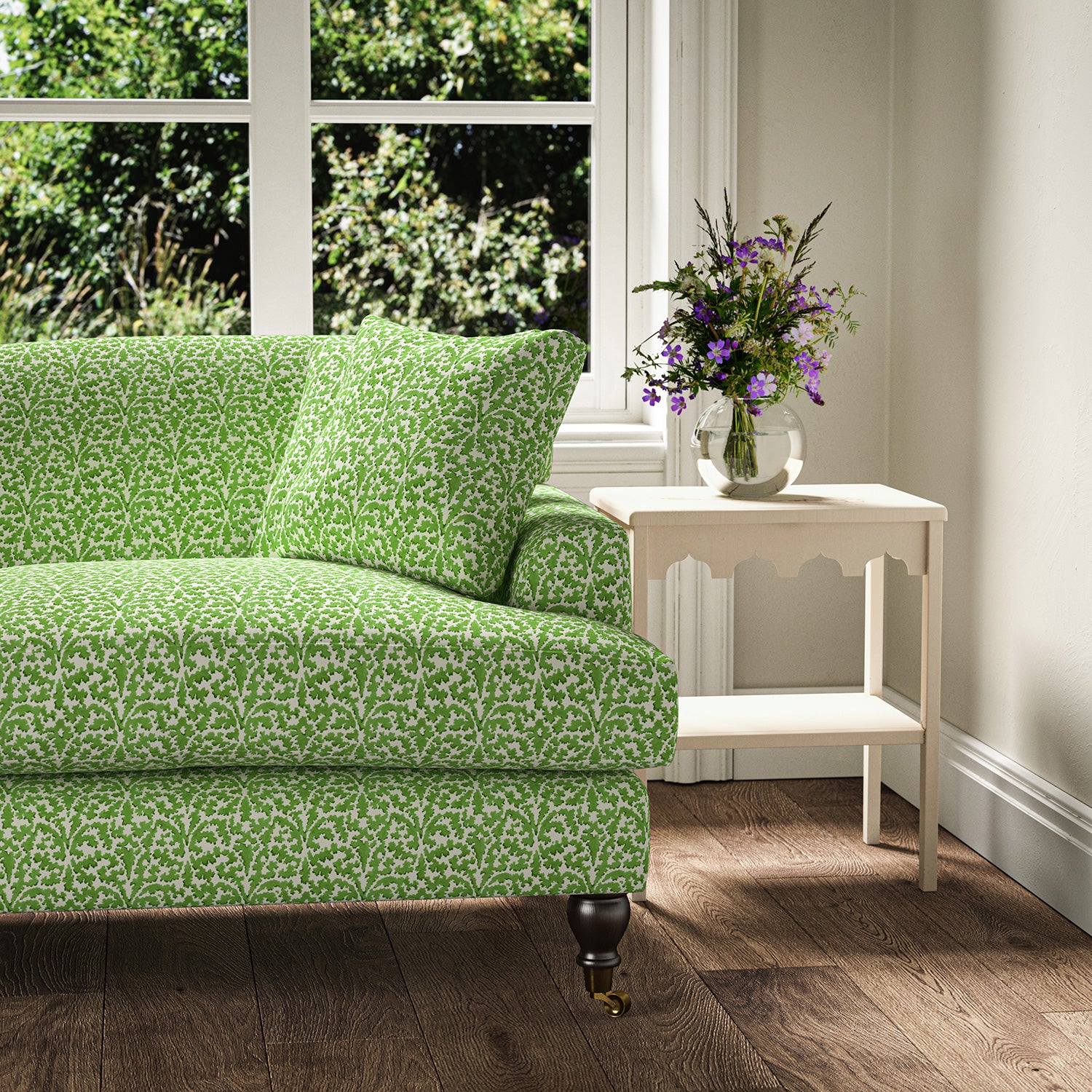 Printed linen fabric – damask-style pattern in green and cream – on a sofa