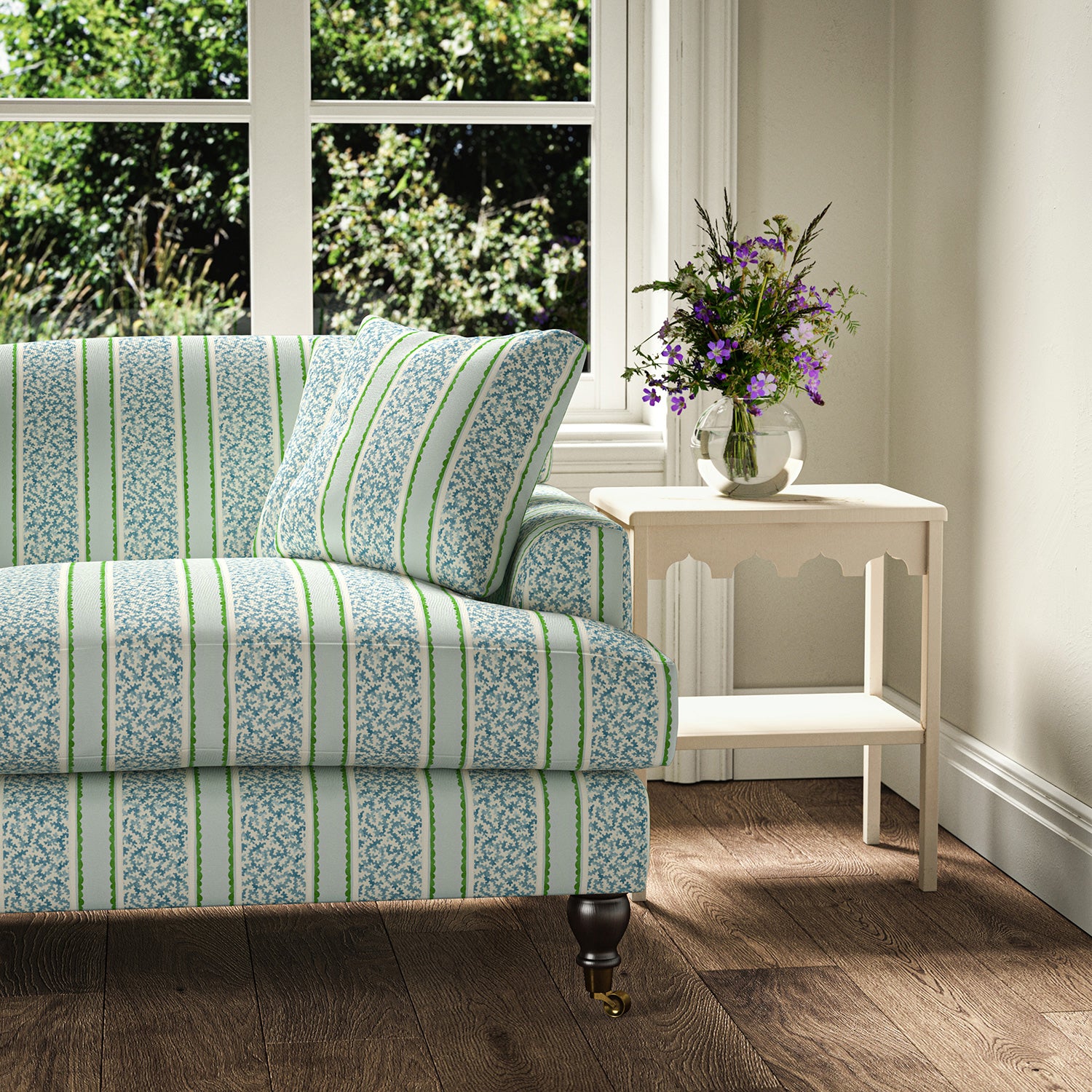 Printed linen fabric - fresh bands of jolly colours in blue, green and cream – on a sofa