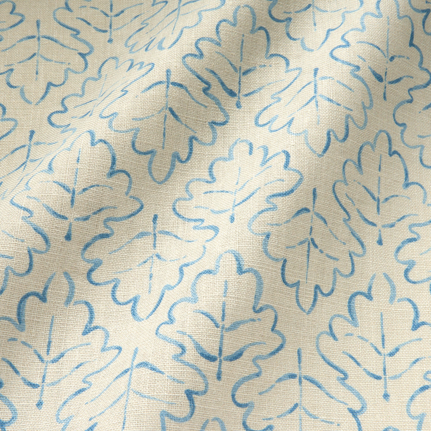 Printed linen fabric sample – a hand drawn; mirrored leaf motif pattern in blue and cream