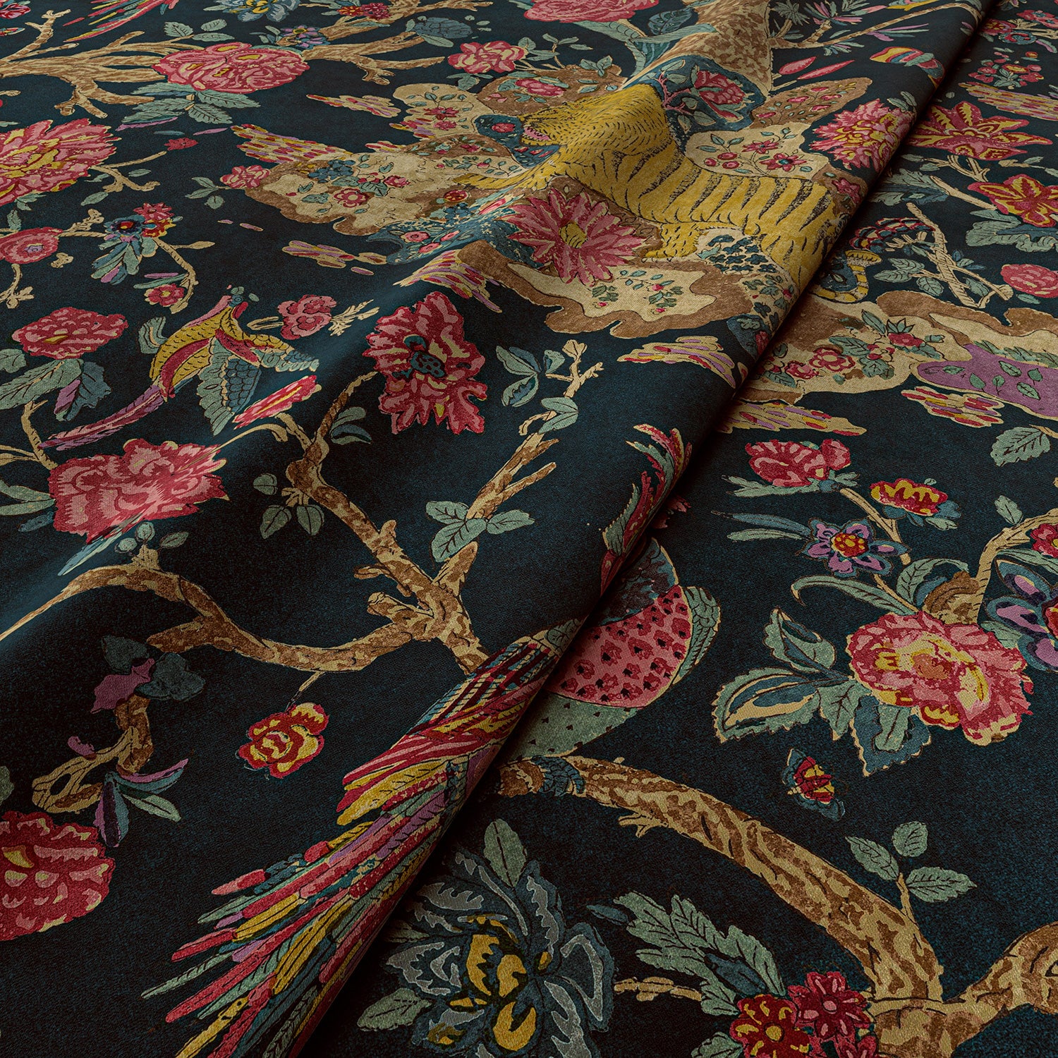 Sample of a printed velvet fabric depicts a menagerie of parrots, lions, and alluring flowers in blue