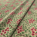 Sample of a printed velvet fabric which captures the beauty of the forest floor: leaves, brand and flowers abound in pink, green and brown