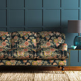 Sofa in a printed velvet fabric showcasing the abundant pattern of stylised flowers in blue