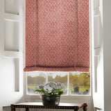Blind in a red and neutral printed linen fabric with a geometric pattern