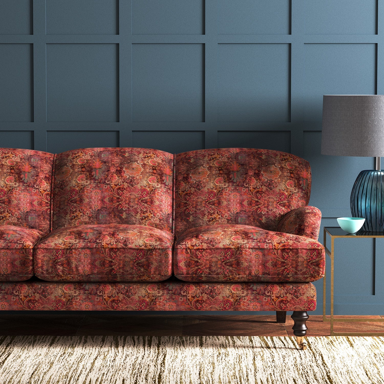 Sofa covered in a terracotta printed velvet fabric based on a classic Persian rug design.