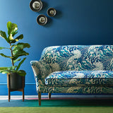 Velvet sofa upholstered in a blue and white velvet upholstery fabric with a wave design and stain resistant finish