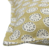 A yellow, cream and black linen cushion with a all-over repeat pattern.