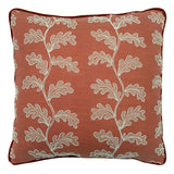 Decorative coral cushion with a off-white leaf pattern.