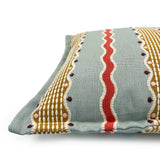 Decorative pillow with colorful patterns on a light gray background