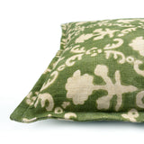 Decorative green pillow with a ivory floral pattern.