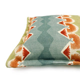 Decorative cushion with geometric pattern in blue, green and ochre.