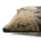Close-up side view of Linwood cushion in Bizarre Multi, showing the fabric texture and green piping detail.
