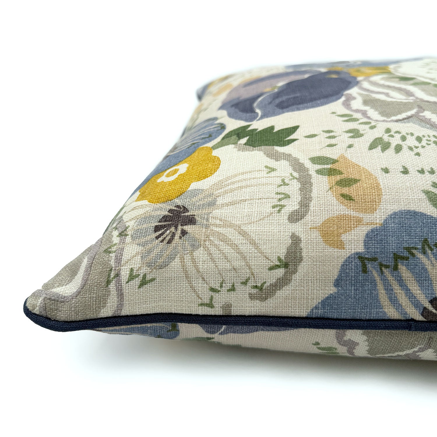 Close-up side view of Linwood cushion in Joni, Chambray showing fabric texture and piping in a complementary dark blue linen.