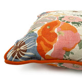 Close-up side view of Linwood cushion in Joni, Tangerine showing fabric texture and piping in a complementary deep orange linen.