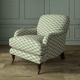 Armchair upholstered in Strata fabric highlighting horizontal texture and tonal depth.