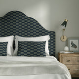Bedroom with upholstered headboard and cushions in Strata fabric in Denim, showing soft texture.