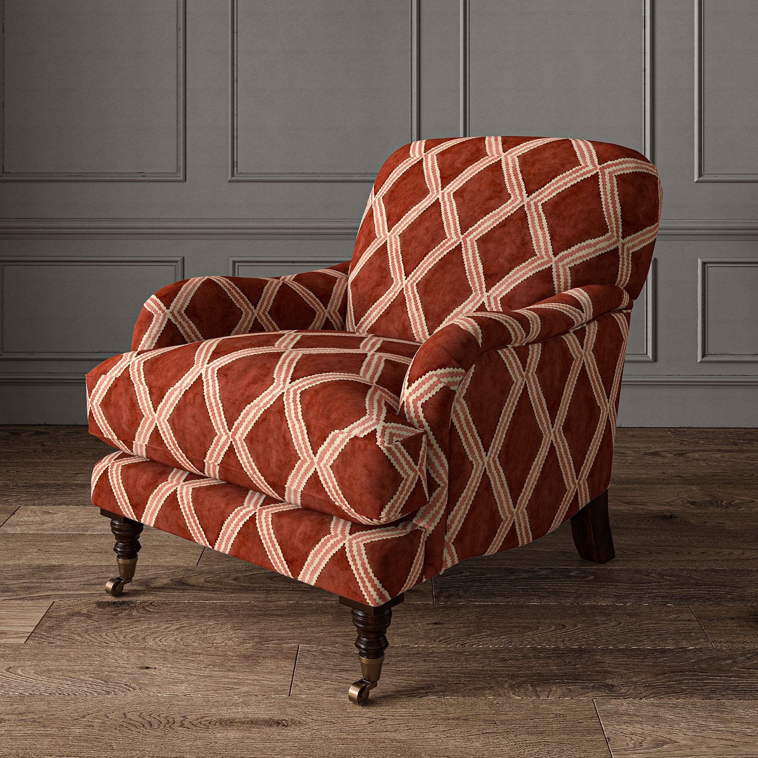 Accent chair upholstered in red and pink printed velvet with an irregular diamond pattern, showcasing the fabric’s rich texture. 