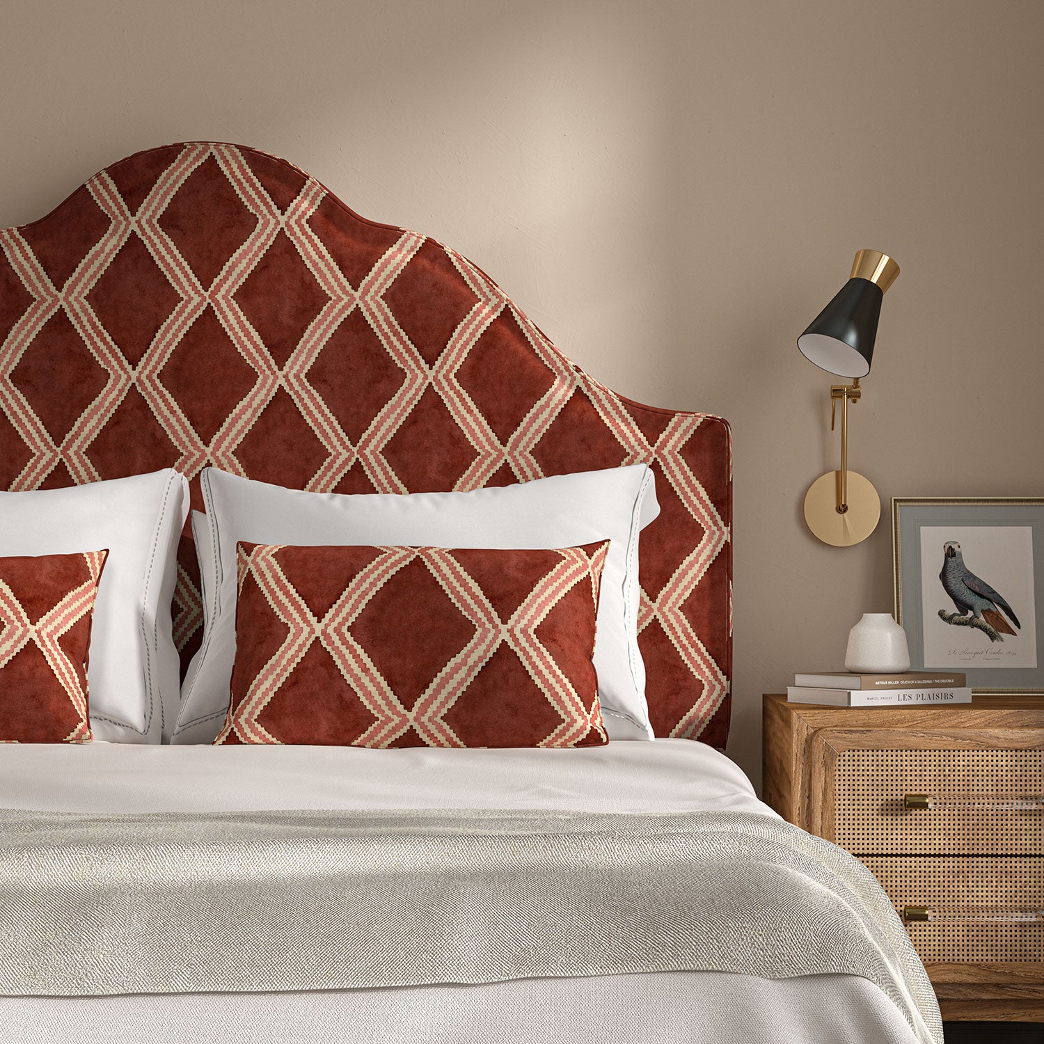 Bedroom with a curved upholstered headboard covered in red and pink printed velvet featuring an irregular diamond motif.