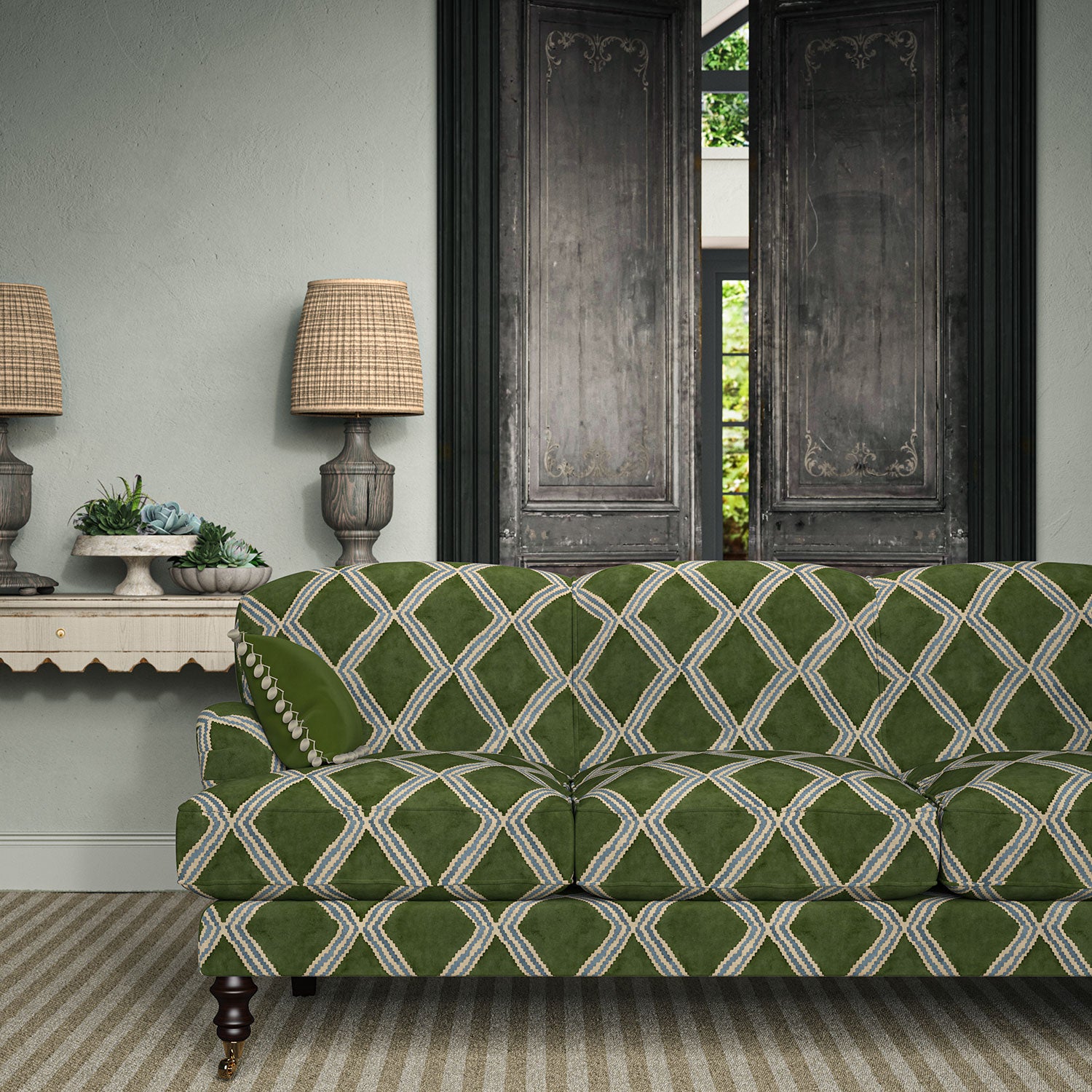 Sofa upholstered in green and blue printed velvet featuring an irregular diamond motif, styled in a timeless living room.