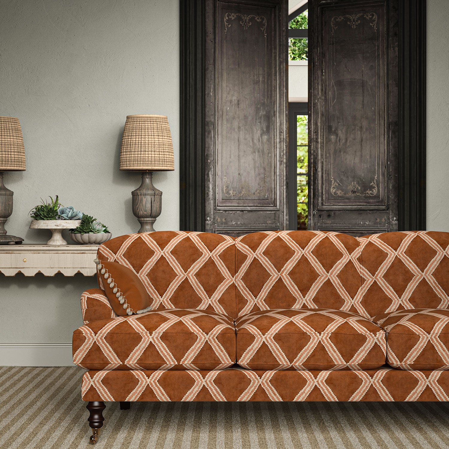 Sofa upholstered in ginger/brown printed velvet featuring an irregular diamond motif, styled in a timeless living room.