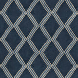 Close-up of blue printed velvet fabric featuring an irregular diamond motif with a soft, luxurious pile. 