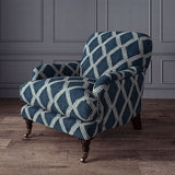 Accent chair upholstered in blue printed velvet with an irregular diamond pattern, showcasing the fabric’s rich texture. 