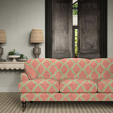 Sofa upholstered in orange and green printed velvet featuring an irregular diamond motif, styled in a timeless living room.