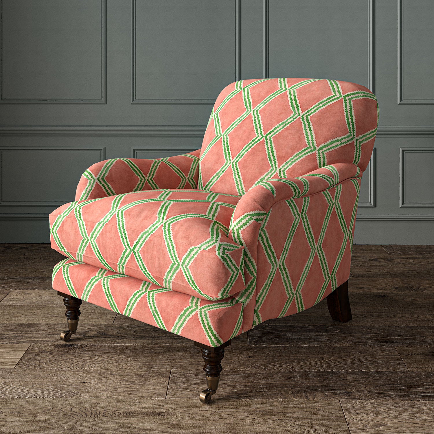 Accent chair upholstered in orange and green printed velvet with an irregular diamond pattern, showcasing the fabric’s rich texture. 