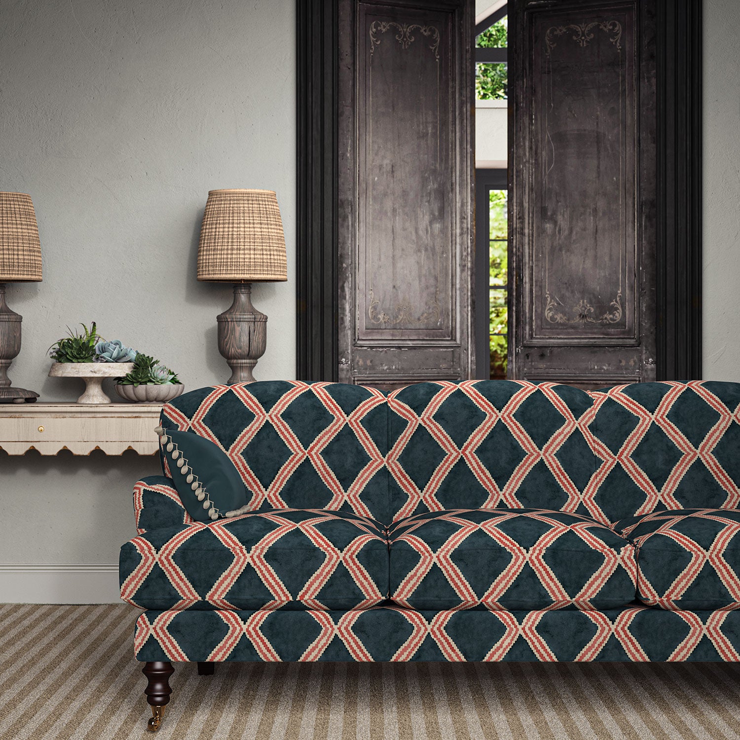 Sofa upholstered in blue and red printed velvet featuring an irregular diamond motif, styled in a timeless living room.
