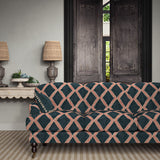 Sofa upholstered in blue and red printed velvet featuring an irregular diamond motif, styled in a timeless living room.