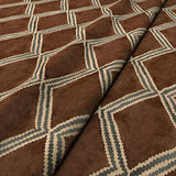 Close-up of brown and blue printed velvet fabric featuring an irregular diamond motif with a soft, luxurious pile. 