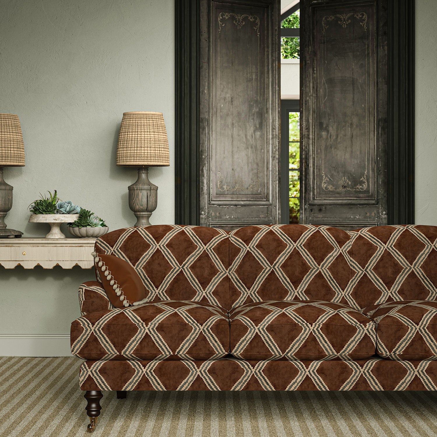 Sofa upholstered in brown and blue printed velvet featuring an irregular diamond motif, styled in a timeless living room.