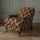 Accent chair upholstered in brown and blue printed velvet with an irregular diamond pattern, showcasing the fabric’s rich texture. 