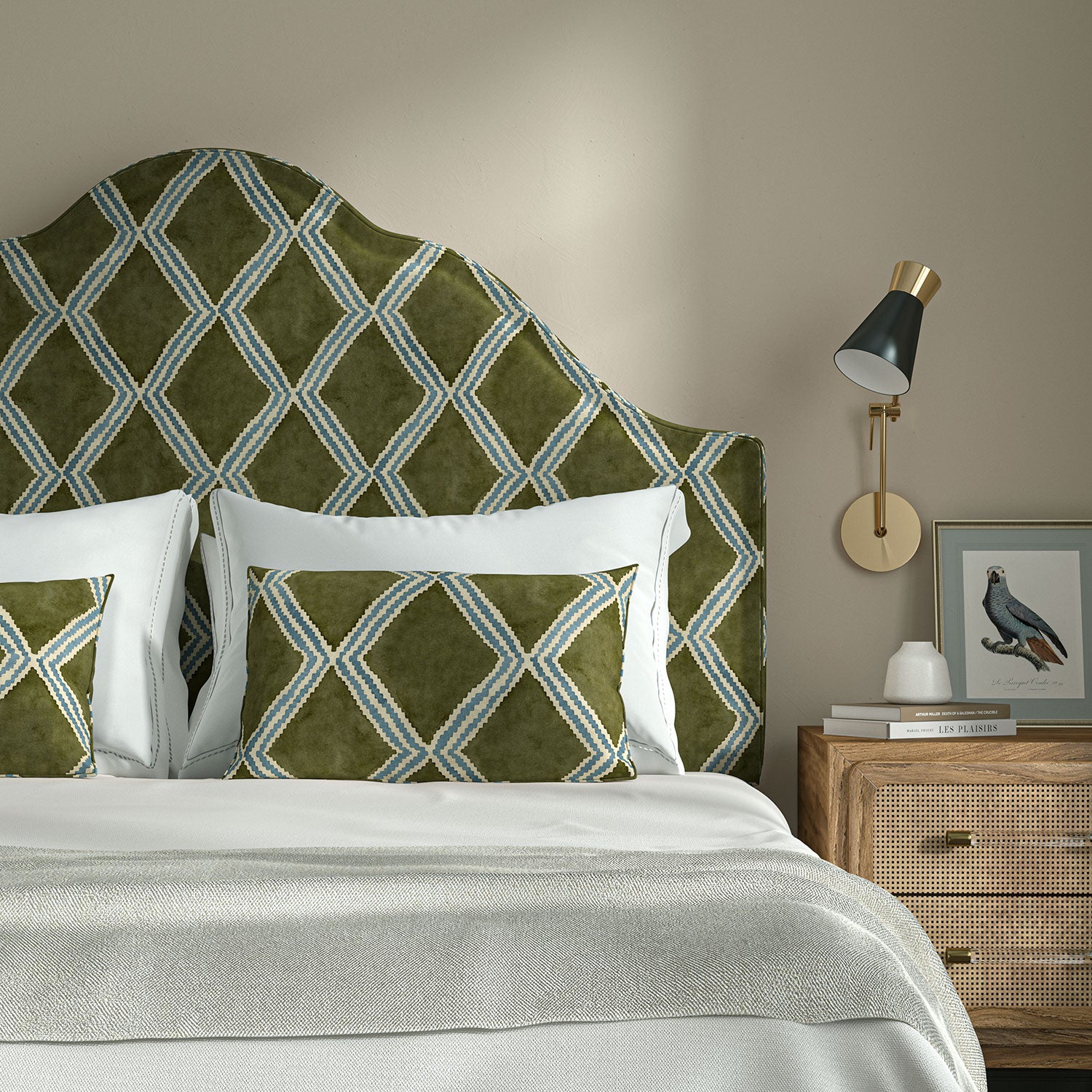 Bedroom with a curved upholstered headboard covered in green and blue printed velvet featuring an irregular diamond motif.