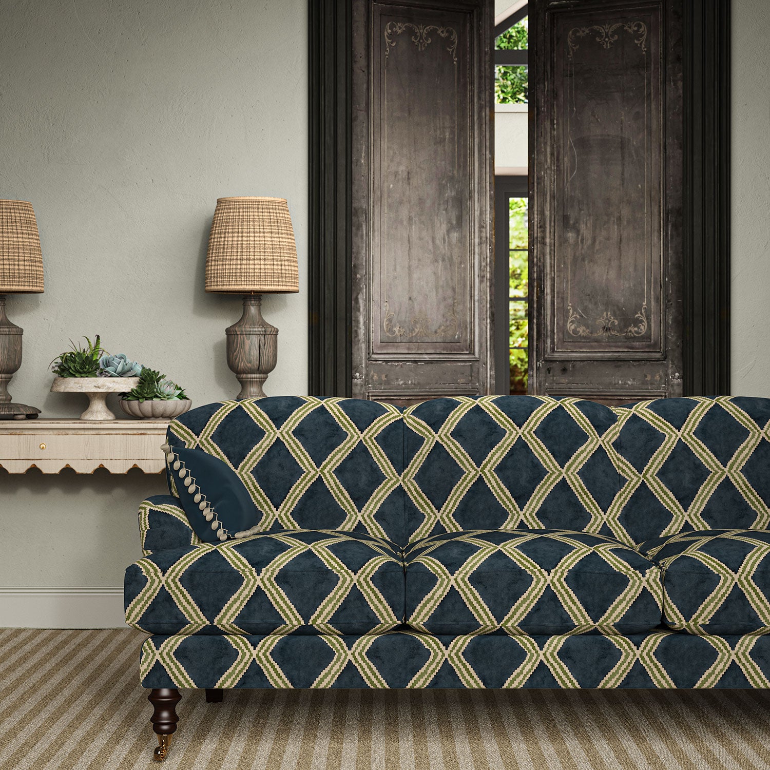 Sofa upholstered in blue and green printed velvet featuring an irregular diamond motif, styled in a timeless living room.