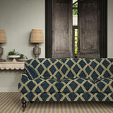 Sofa upholstered in blue and green printed velvet featuring an irregular diamond motif, styled in a timeless living room.
