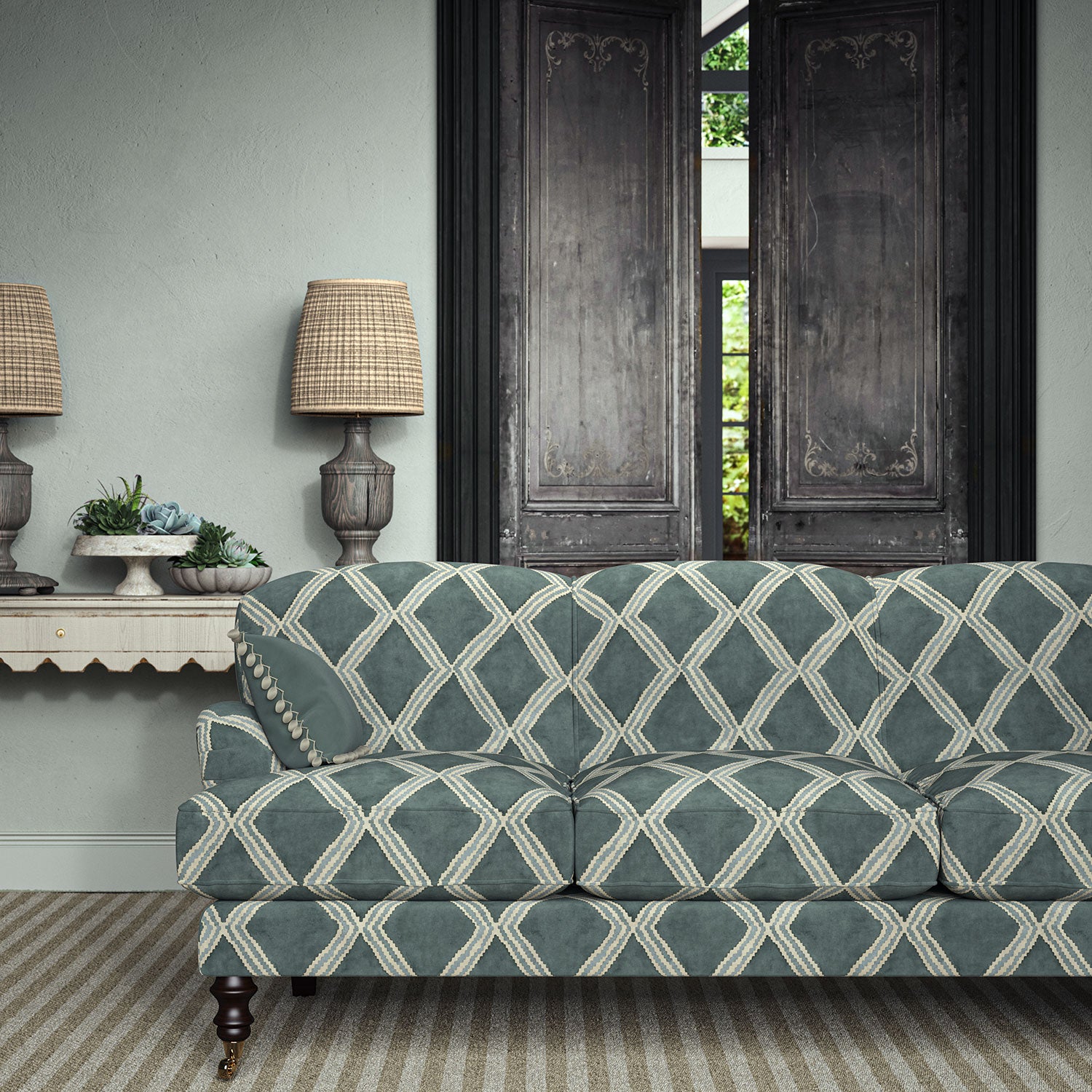 Sofa upholstered in blue printed velvet featuring an irregular diamond motif, styled in a timeless living room.