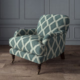 Accent chair upholstered in blue printed velvet with an irregular diamond pattern, showcasing the fabric’s rich texture. 