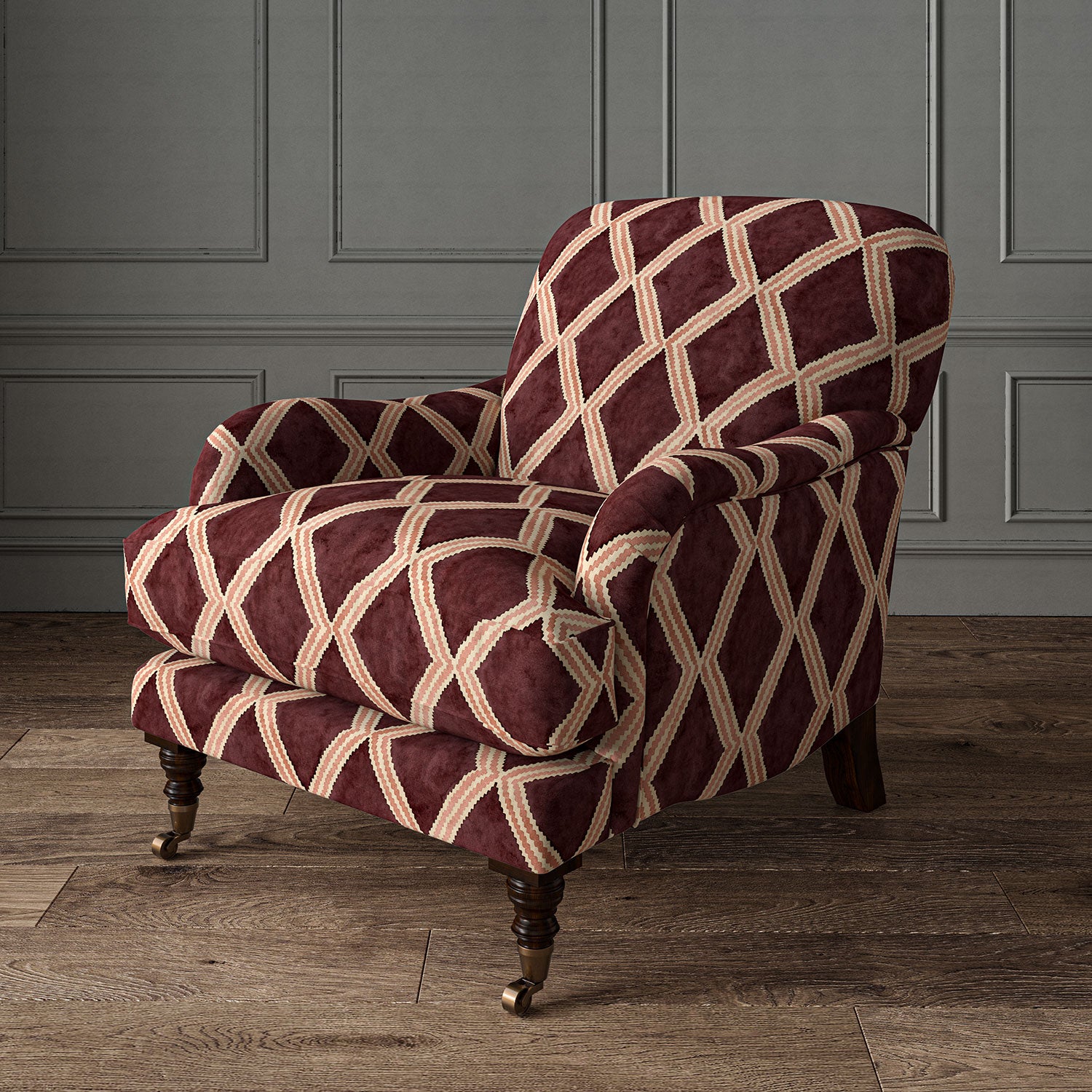 Accent chair upholstered in maroon and pink printed velvet with an irregular diamond pattern, showcasing the fabric’s rich texture. 