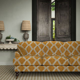 Sofa upholstered in brown and blue printed velvet featuring an irregular diamond motif, styled in a timeless living room.