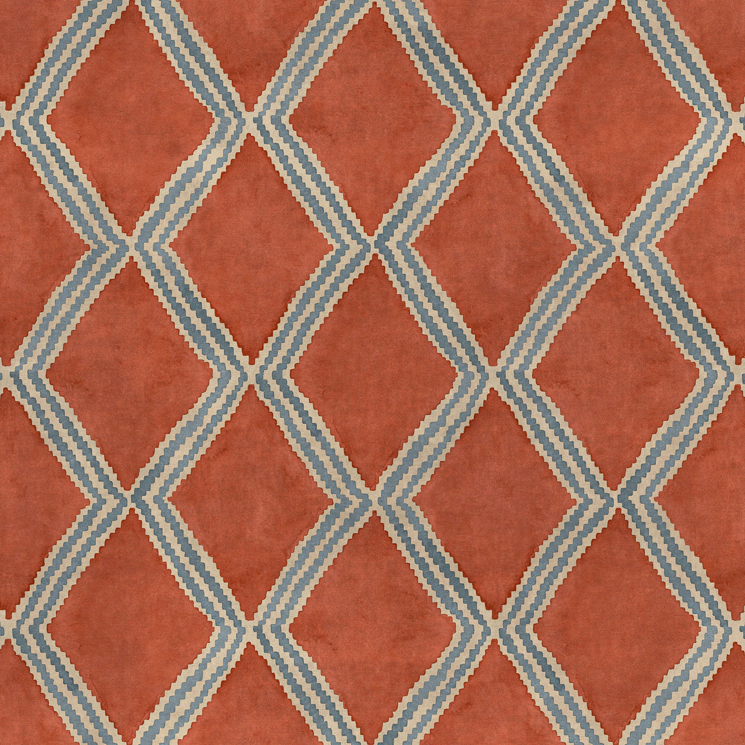 Close-up of orange and blue printed velvet fabric featuring an irregular diamond motif with a soft, luxurious pile. 
