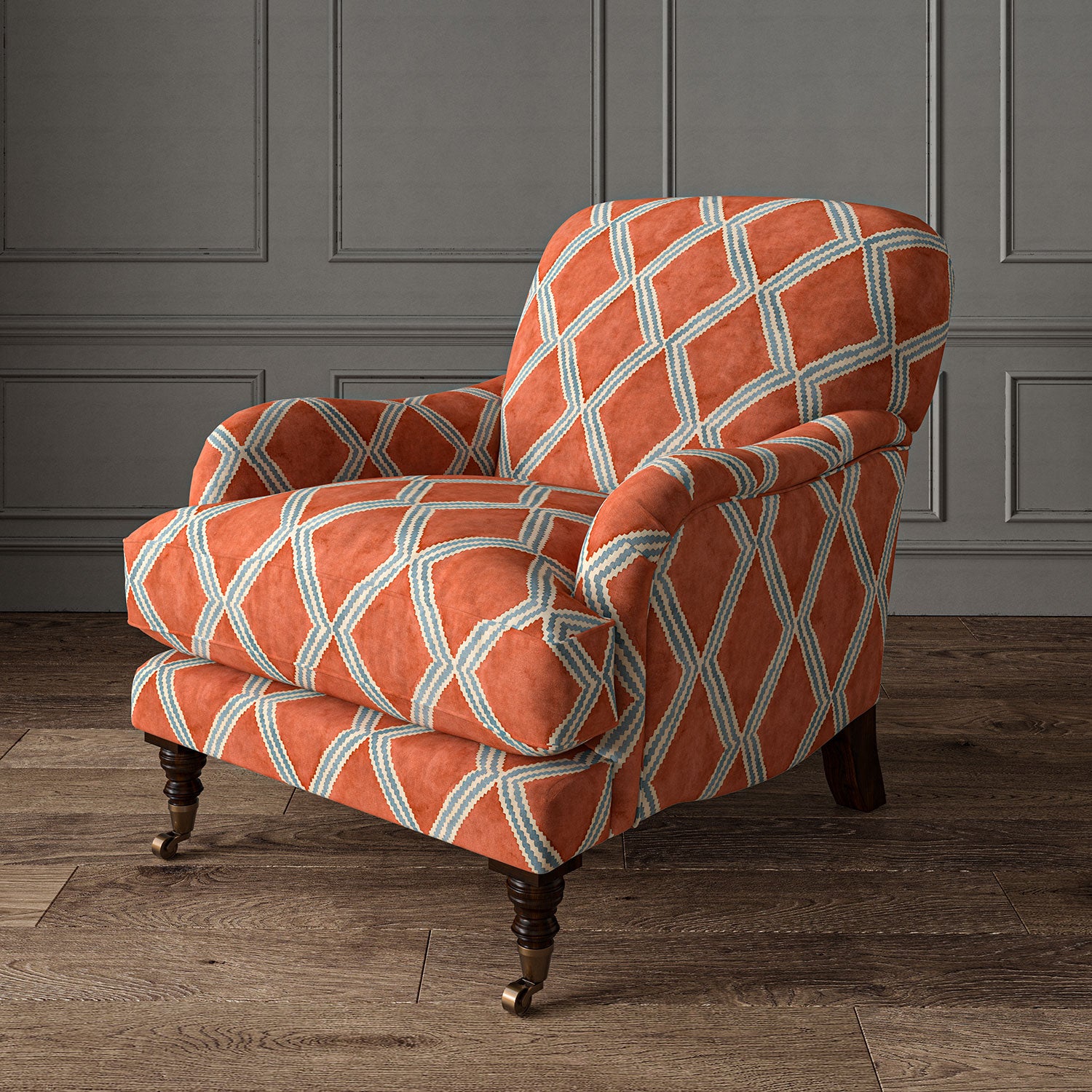 Accent chair upholstered in orange and blue printed velvet with an irregular diamond pattern, showcasing the fabric’s rich texture. 
