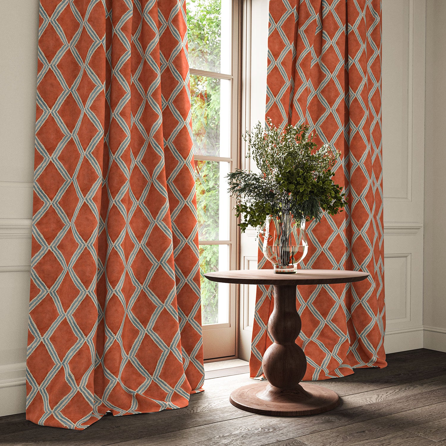 Orange and blue printed velvet curtains with an irregular diamond pattern framing a tall window.