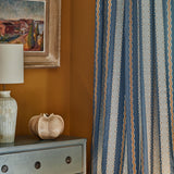 Embroidery curtain fabric with blue, beige, and white stripes on a blue background.