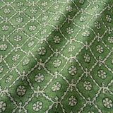 Linen fabric with a hand block-style pattern in green, black and cream