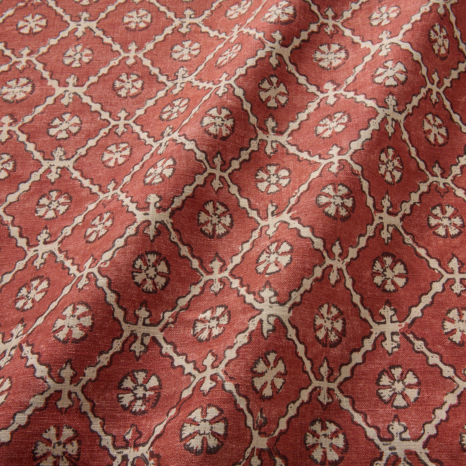 Linen fabric with a hand block-style pattern in red, black and cream
